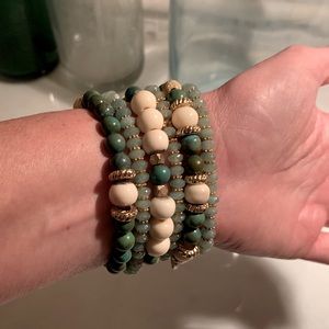6 jade green, off white & gold beaded bracelets on elastic cord.
